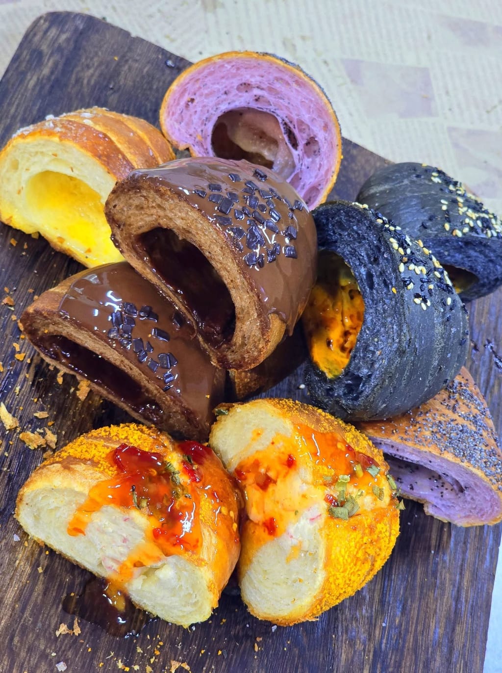 Cross section of surprise-filled buns with taro, chocolate, charcoal and sambal fillings
