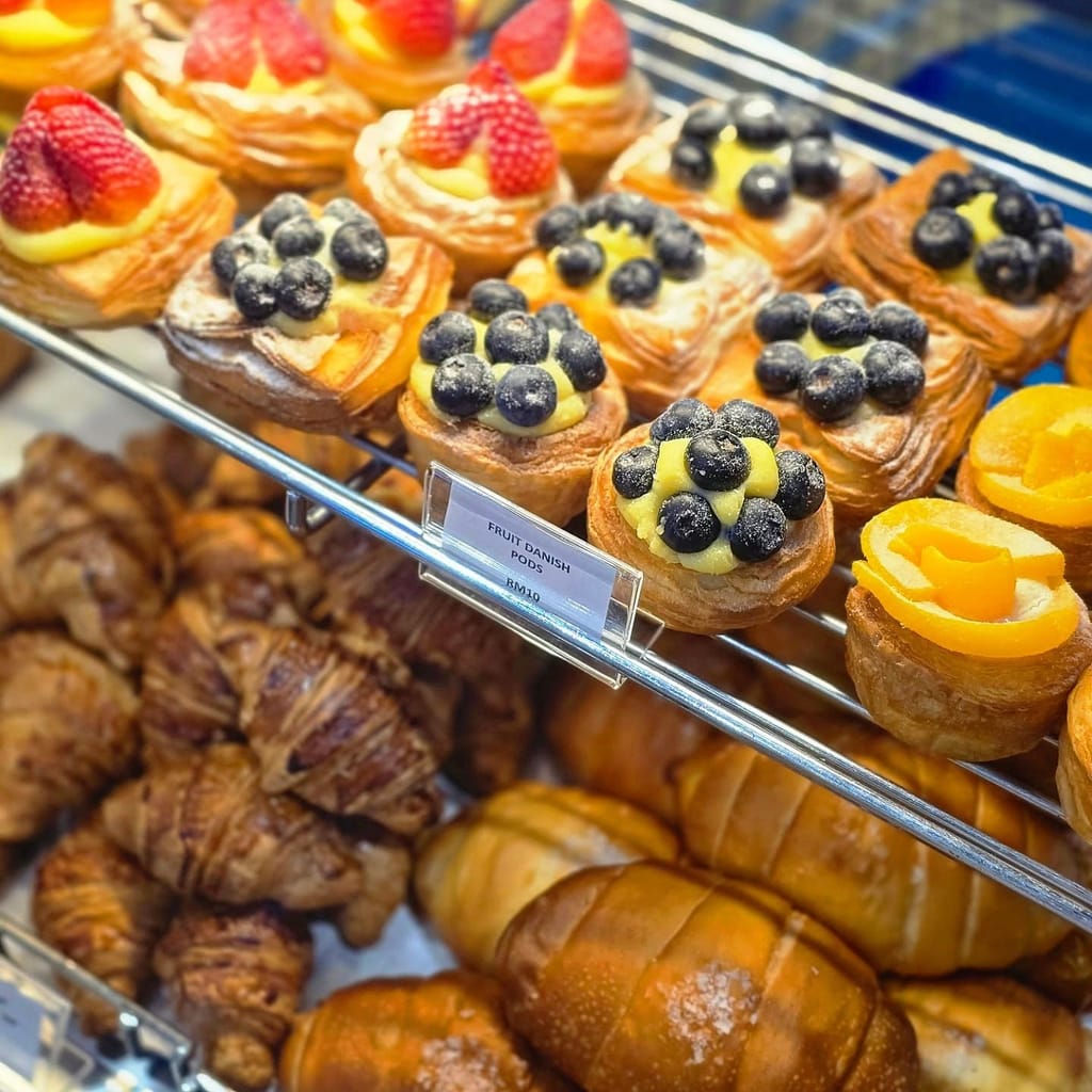 Fruit danish pods topped with blueberries, strawberries and pastry cream